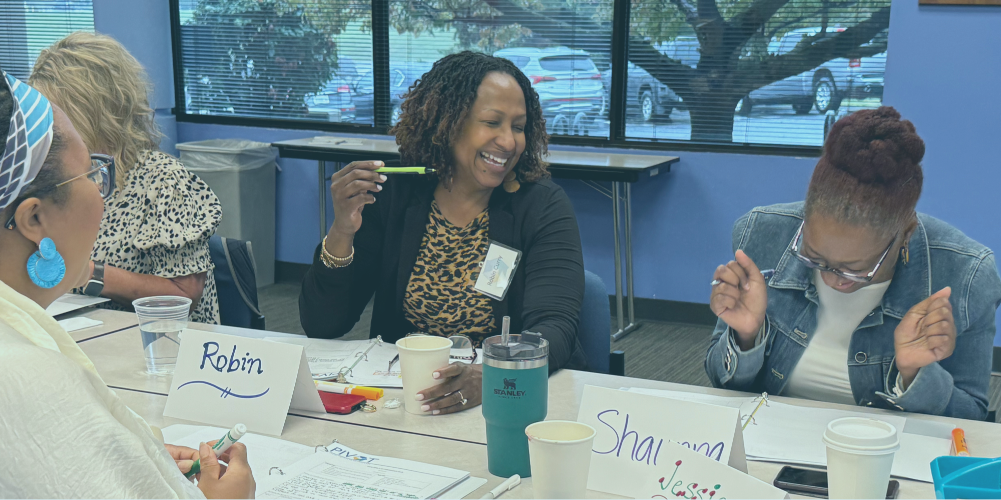 Women sitting around a table and smiling