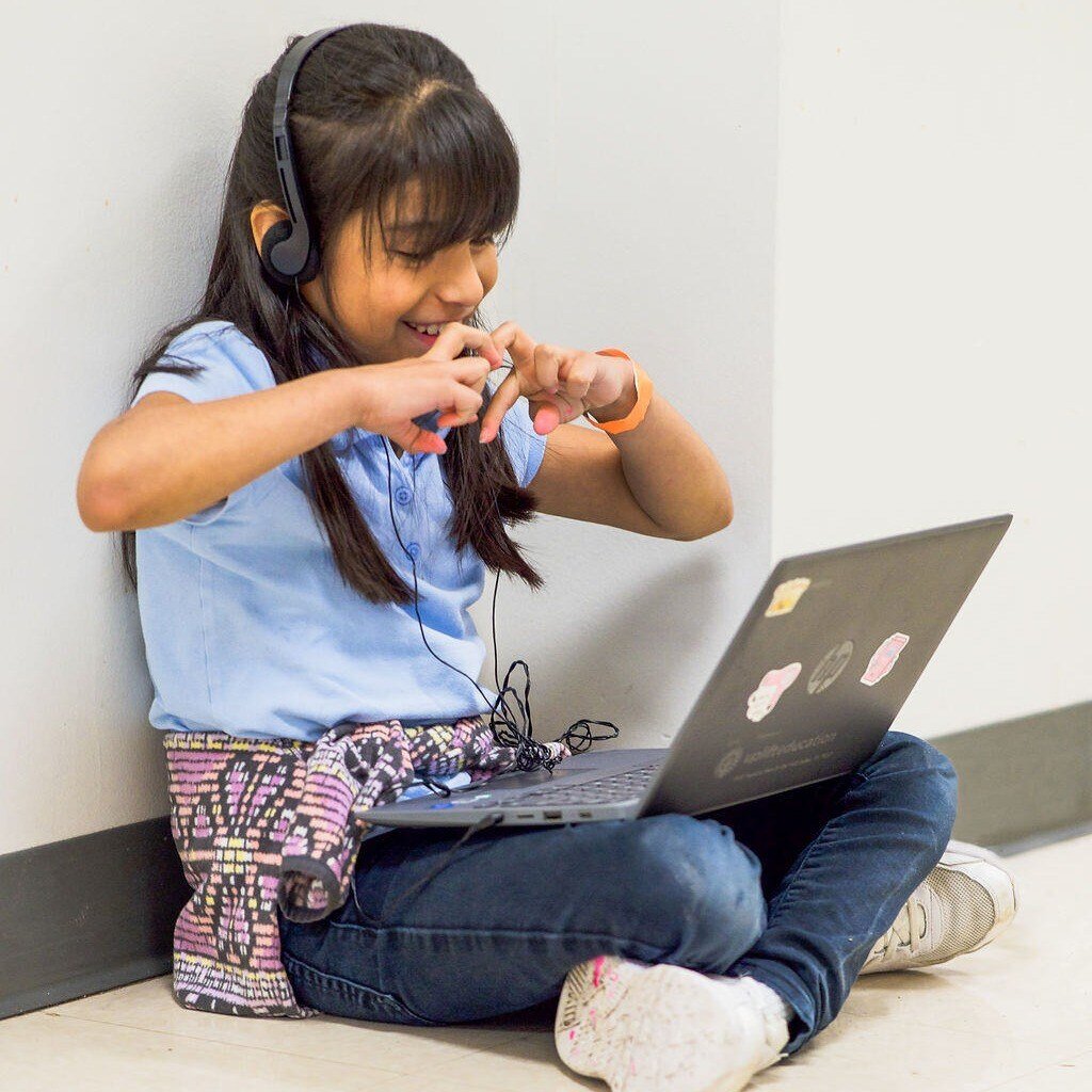 girl making her hands into a heart for her virtual tutor